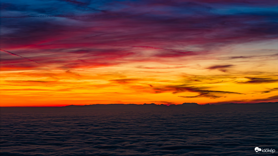 Lángoló égbolt a köd felett